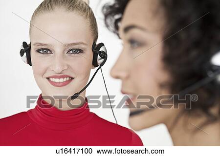 Businesswomen wearing headsets View Large Photo Image Stock Image - Businesswomen wearing headsets. Fotosearch