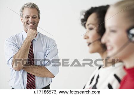 Stock Image - Businesswomen wearing headsets. Fotosearch