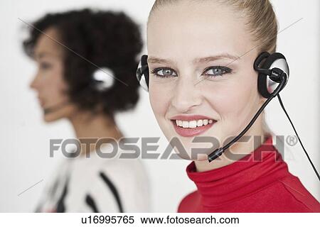 Stock Photography - Businesswomen wearing headsets. Fotosearch