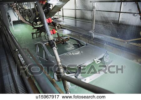 Stock Photo - Car bodies being dipped in car factory. Fotosearch