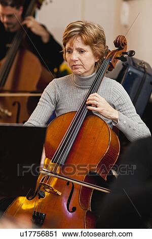 Cello player practicing with group View Large Photo Image Stock Image - Cello player practicing with group. Fotosearch