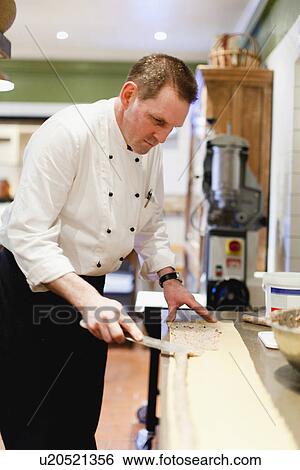 Stock Photograph - Chef at work in restaurant kitchen. Fotosearch