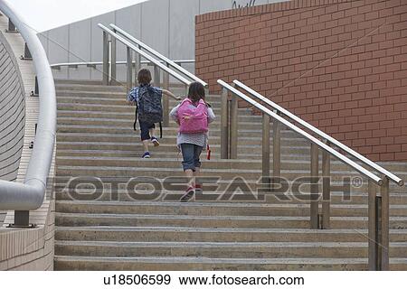 Stock Photo - Children climbing stairs outdoors. Fotosearch
