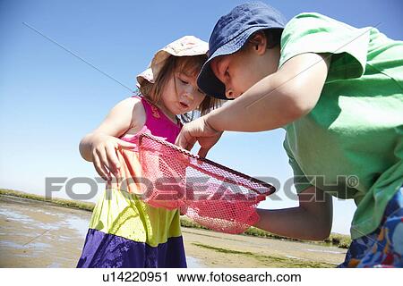 Children examining fishing nets View Large Photo Image Stock Image - Children examining fishing nets. Fotosearch