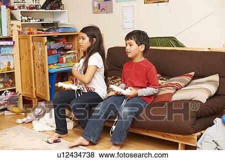 Children playing video games together View Large Photo Image Stock Photo - Children playing video games together. Fotosearch