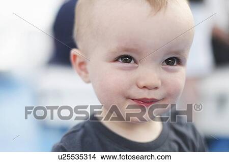 Picture - Close up of baby boys smiling face. Fotosearch