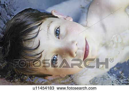 Close up of boys face in river View Large Photo Image Stock Image - Close up of boys face in river. Fotosearch