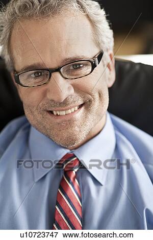 Stock Photo - Close up of businessmans smiling face. Fotosearch