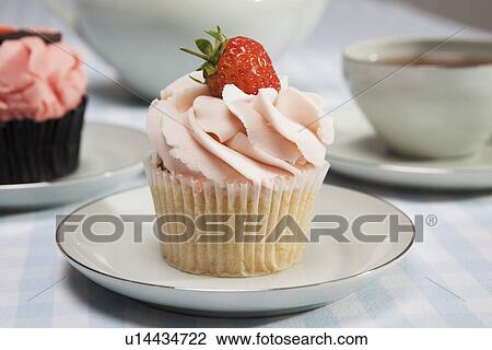 Stock Image - Close up of cupcake with strawberry. Fotosearch