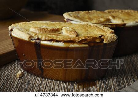 Picture - Close up of dishes of baked pie. Fotosearch