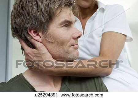 Stock Image - Close up of doctor examining patient. Fotosearch