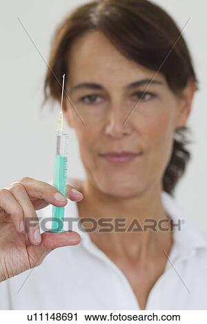 Close up of doctor preparing syringe View Large Photo Image Stock Image - Close up of doctor preparing syringe. Fotosearch