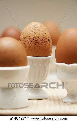 Close up of eggs in egg cups View Large Photo Image Stock Photo - Close up of eggs in egg cups. Fotosearch