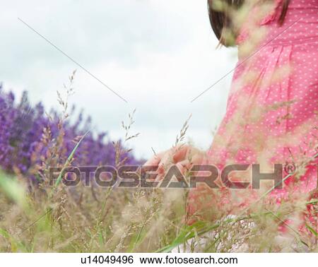 Close up of girl in field of flowers View Large Photo Image Stock Photograph - Close up of girl in field of flowers. Fotosearch