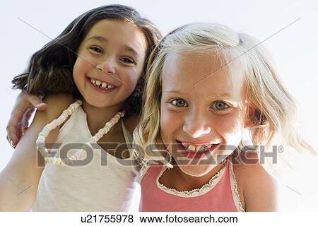 Close up of girls hugging outdoors View Large Photo Image Stock Photo - Close up of girls hugging outdoors. Fotosearch