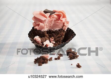 Stock Photo - Close up of half eaten cupcake. Fotosearch