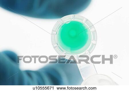 Close up of scientist holding liquid View Large Photo Image Stock Image - Close up of scientist holding liquid. Fotosearch