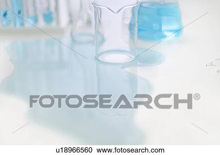 Stock Image - Close up of spilled liquid in lab. Fotosearch