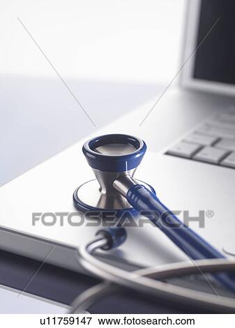 Close up of stethoscope on laptop View Large Photo Image Stock Photo - Close up of stethoscope on laptop. Fotosearch
