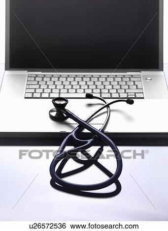 Stock Photograph - Close up of stethoscope on laptop. Fotosearch