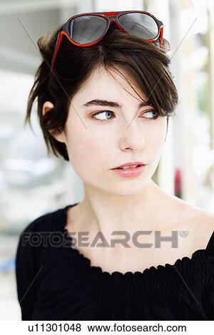 Stock Photo - Close up of woman wearing sunglasses. Fotosearch
