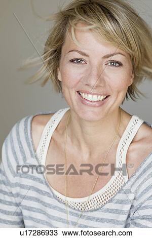 Stock Image - Close up of womans smiling face. Fotosearch