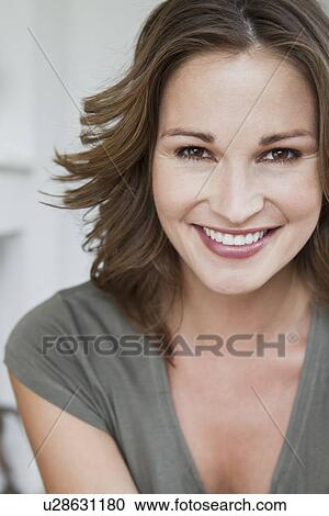 Stock Image - Close up of womans smiling face. Fotosearch