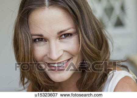 Close up of womans smiling face View Large Photo Image Stock Photo - Close up of womans smiling face. Fotosearch