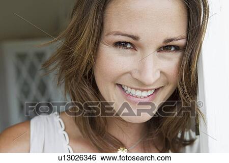 Stock Photograph - Close up of womans smiling face. Fotosearch