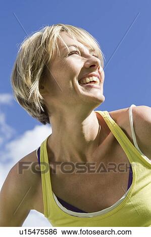 Stock Photograph - Close up of womans smiling face. Fotosearch