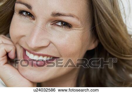 Stock Photograph - Close up of womans smiling face. Fotosearch