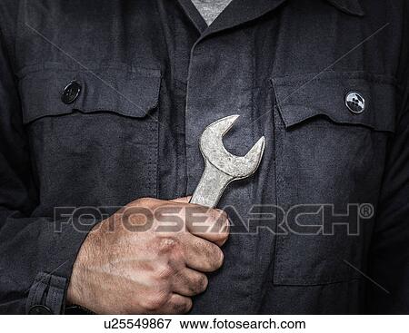 Close up of worker holding wrench View Large Photo Image Stock Photo - Close up of worker holding wrench. Fotosearch