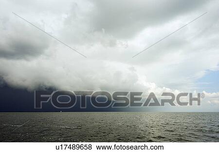 Stock Photo - Clouds looming over ocean. Fotosearch