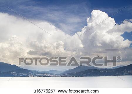 Stock Photo - Clouds over snowy landscape. Fotosearch