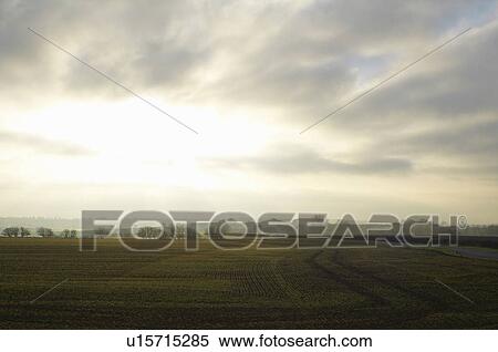 Stock Photography - Cloudy sky over rural landscape. Fotosearch