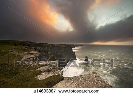 Colorful clouds over coastal cliffs View Large Photo Image Stock Photo - Colorful clouds over coastal cliffs. Fotosearch