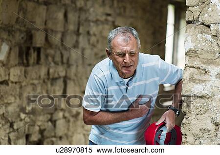 Construction worker clutching his chest View Large Photo Image Stock Photography - Construction worker clutching his chest. Fotosearch