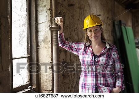 Construction worker smiling on site View Large Photo Image Stock Photo - Construction worker smiling on site. Fotosearch