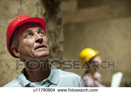 Picture - Construction worker wearing hard hat. Fotosearch