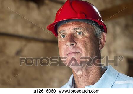 Construction worker wearing hard hat View Large Photo Image Stock Image - Construction worker wearing hard hat. Fotosearch