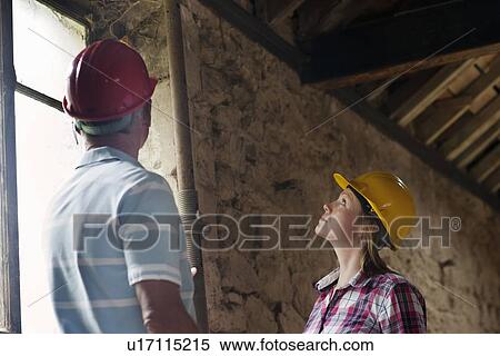 Construction workers examining pipe View Large Photo Image Stock Photography - Construction workers examining pipe. Fotosearch
