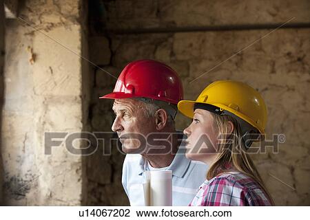 Construction workers standing on site View Large Photo Image Stock Image - Construction workers standing on site. Fotosearch