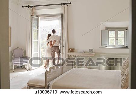 Stock Photo - Couple admiring view from balcony. Fotosearch