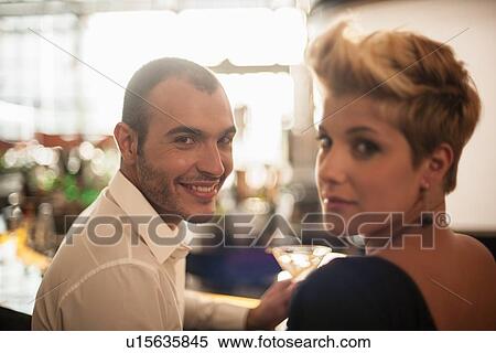 Couple having drinks at bar View Large Photo Image Stock Photography - Couple having drinks at bar. Fotosearch