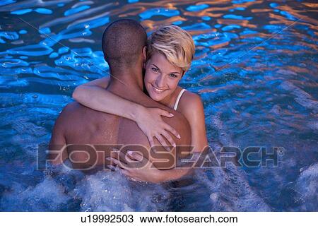 Couple relaxing in indoor jacuzzi View Large Photo Image Stock Image - Couple relaxing in indoor jacuzzi. Fotosearch