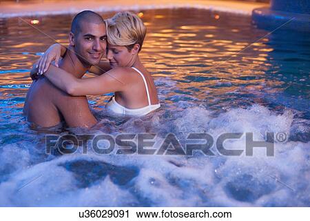 Couple relaxing in indoor jacuzzi View Large Photo Image Stock Image - Couple relaxing in indoor jacuzzi. Fotosearch