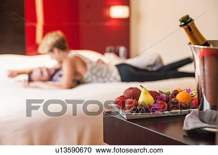 Couple relaxing on hotel room bed View Large Photo Image Stock Image - Couple relaxing on hotel room bed. Fotosearch