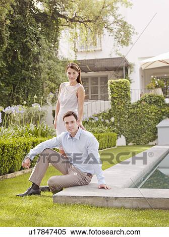 Stock Photography - Couple smiling in garden. Fotosearch