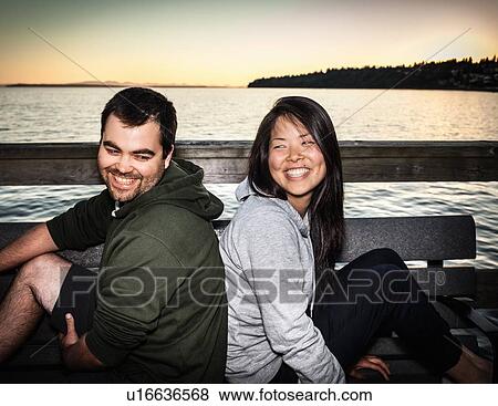 Stock Photo - Couple smiling together outdoors. Fotosearch