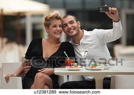 Stock Photo - Couple taking picture of themselves. Fotosearch